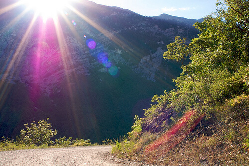 lens flare photography peeking over the sun