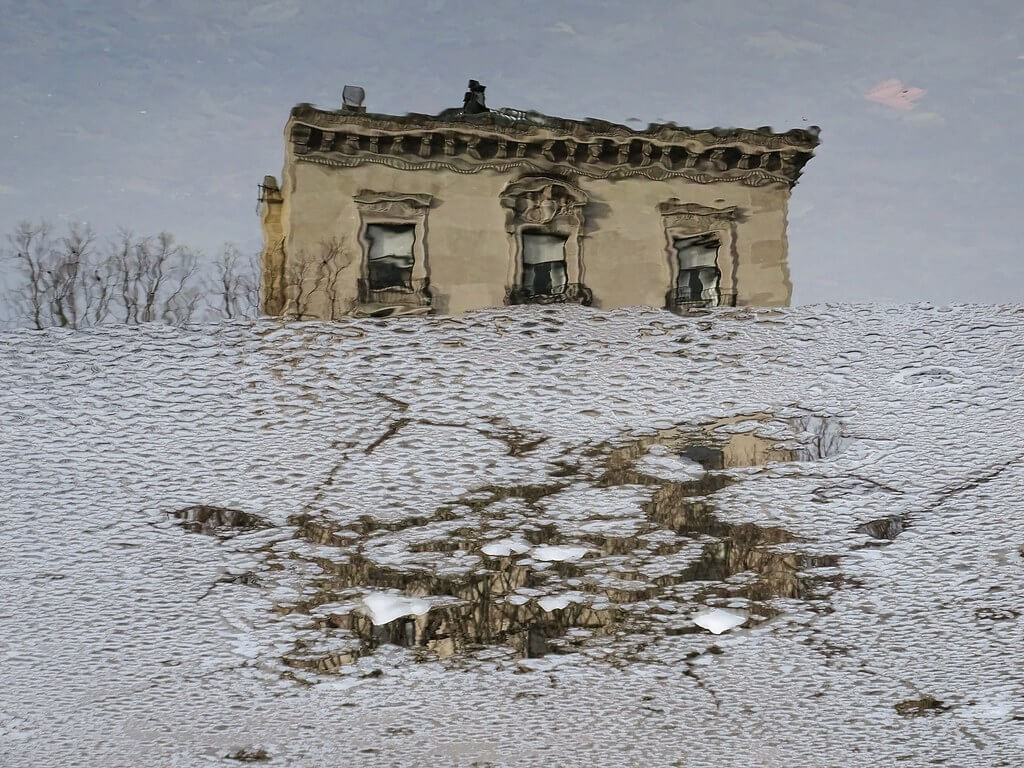 David Smith - Building on 5th Avenue, NYC reflected in pond ice, Central Park
