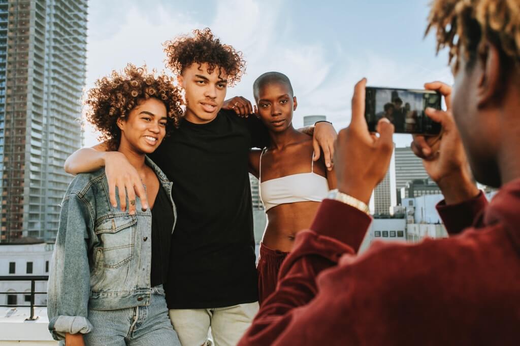 Guy taking a photo of his friends on a rooftop