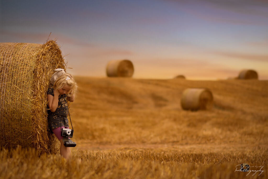 Malgorzata Kapustka -August portrait with hay bales