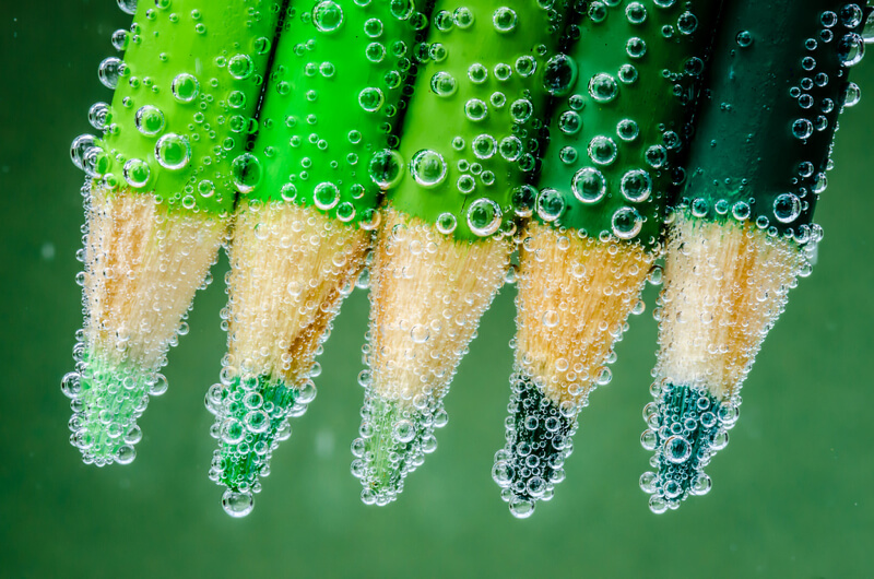 still life photography green pencils under water